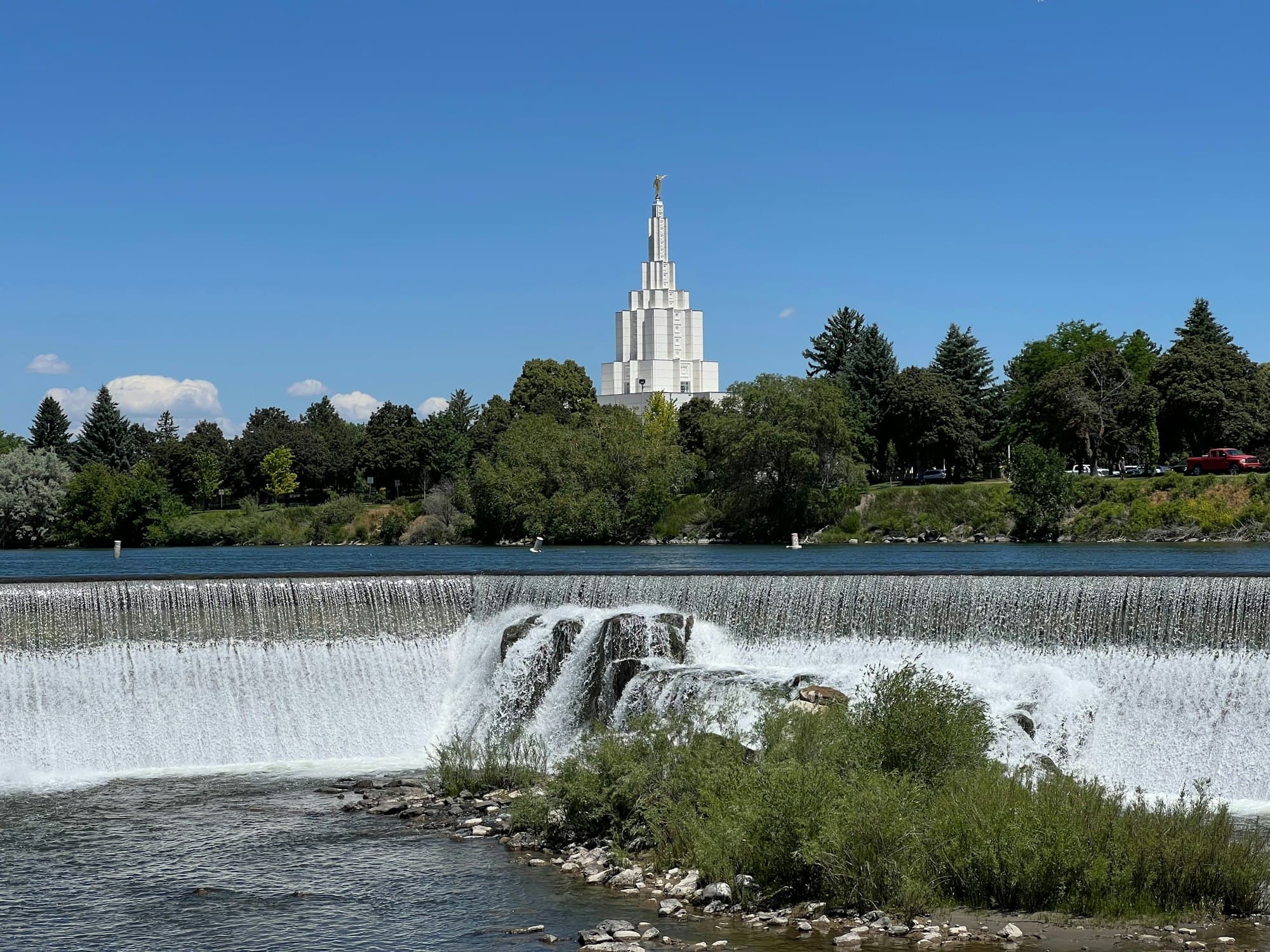 The falls on the Snake River at Idaho Falls, with the temple behind