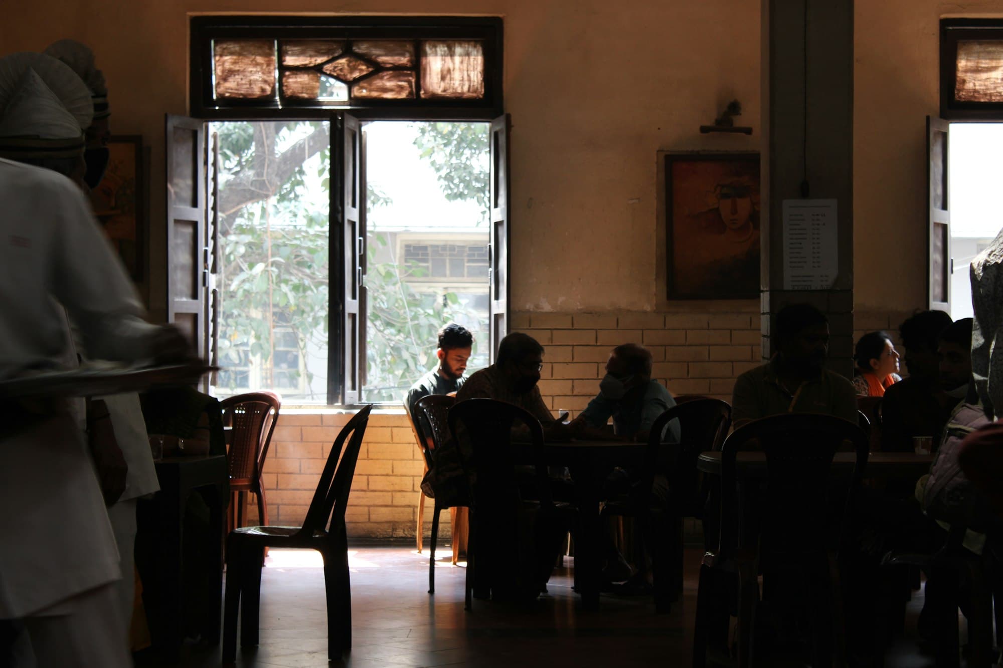 People at the tables of a Kolkata coffee house